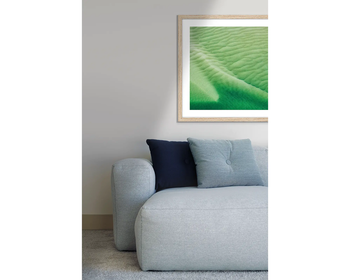 Shallows. Hill Inlet framed wall art print, with a Tasmanian Oak frame, hung above a couch.