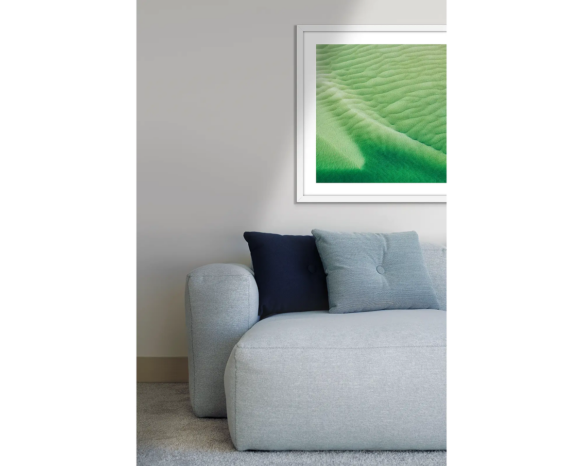 Shallows. Hill Inlet framed wall art print, with a white frame, hung above a couch.