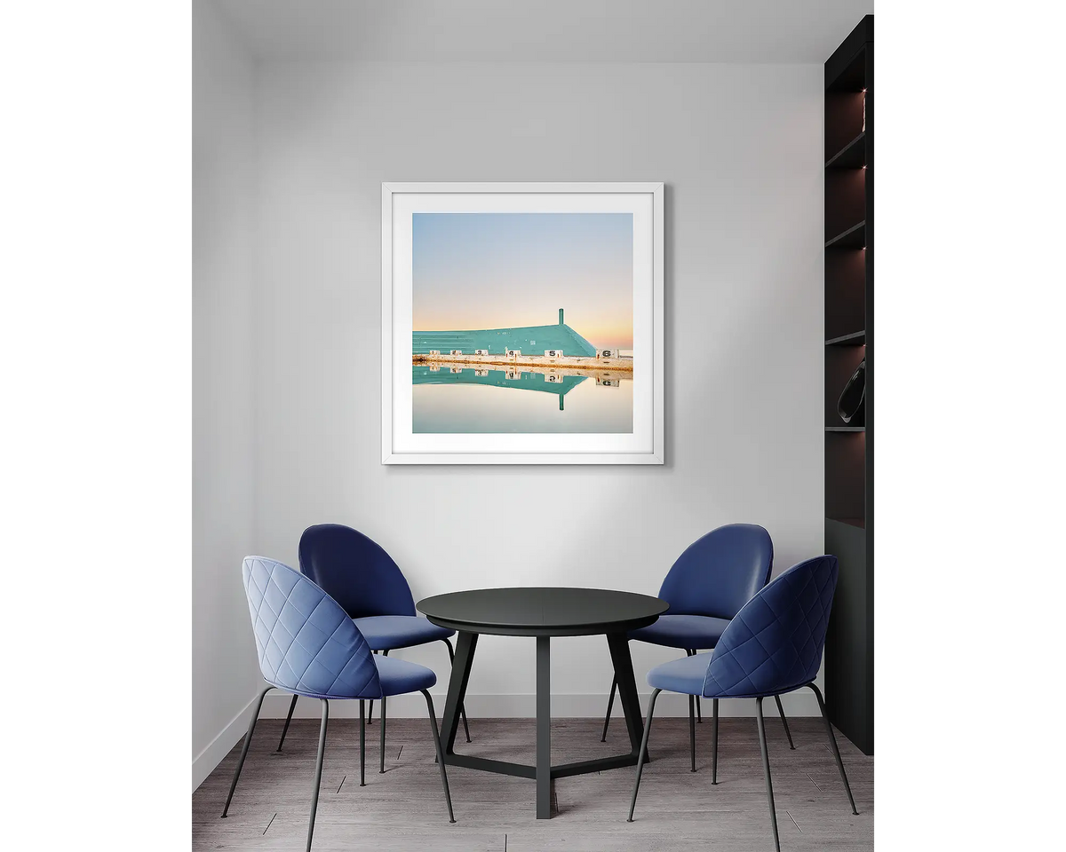 Six. Newcastle Baths wall art print, with a white frame, in an office meeting room. 