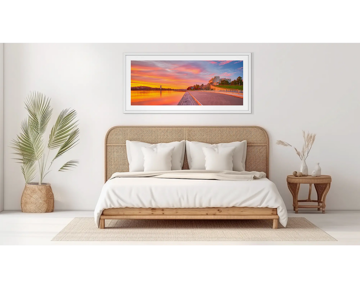 Sky Light. Canberra sunrise wall art, in a white frame, in a bedroom. 