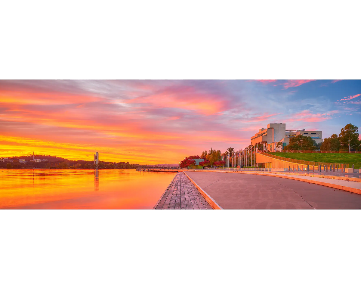 Sky Light. Orange sunrise over the National Carillon and the High Court of Australia, Canberra.