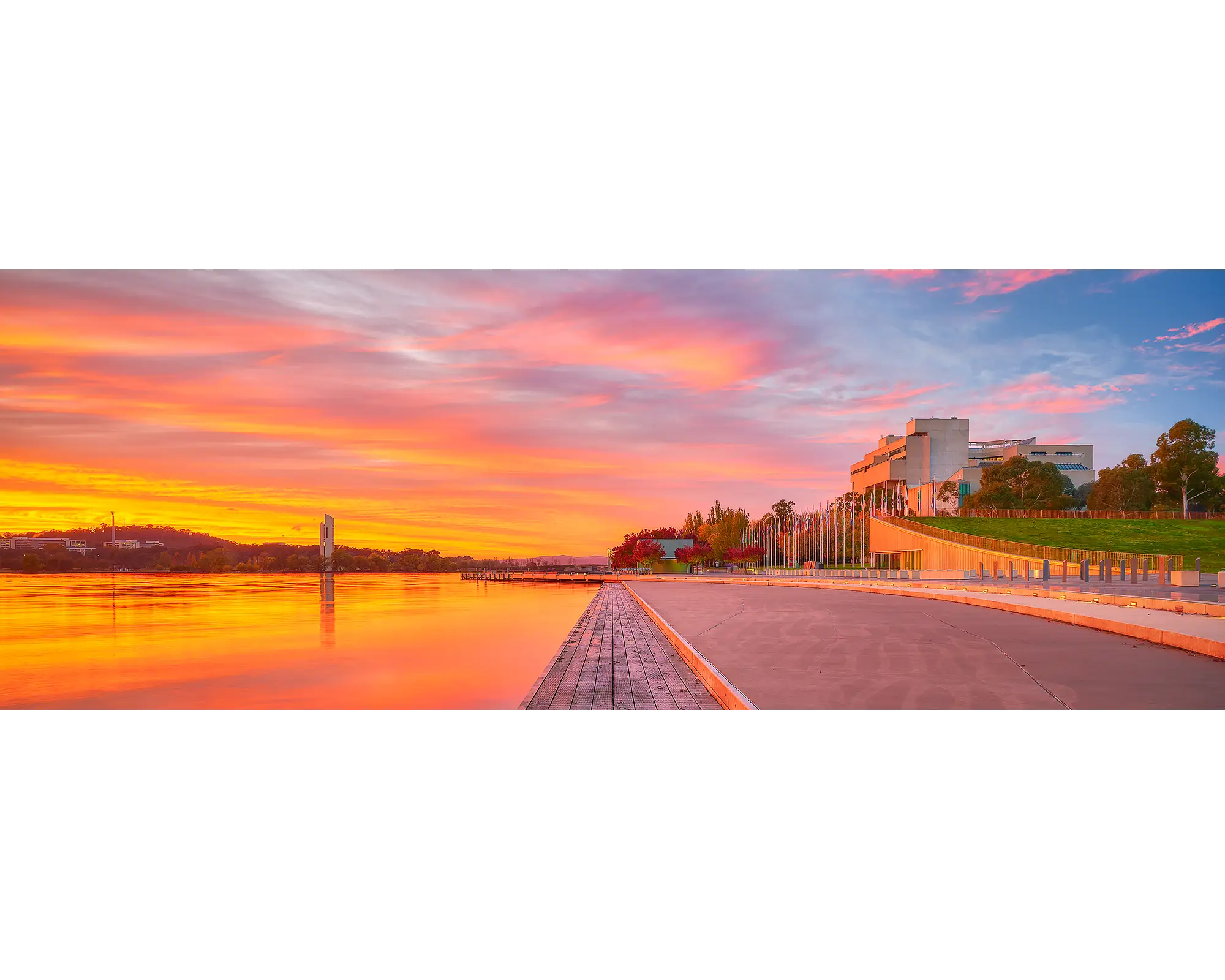 Sky Light. Orange sunrise over the National Carillon and the High Court of Australia, Canberra.