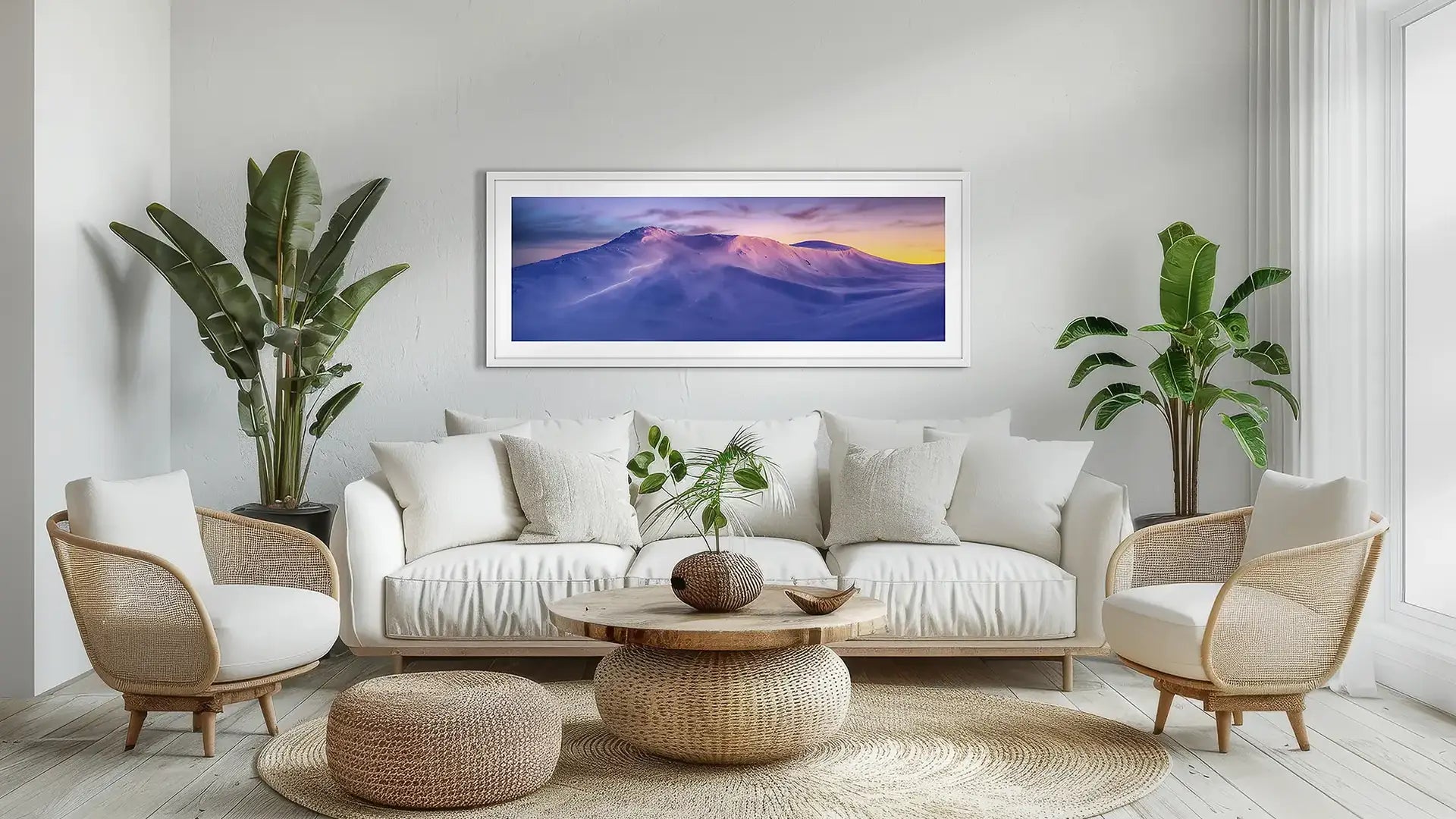 Snowy Mountains wall art print with white frame above couch.