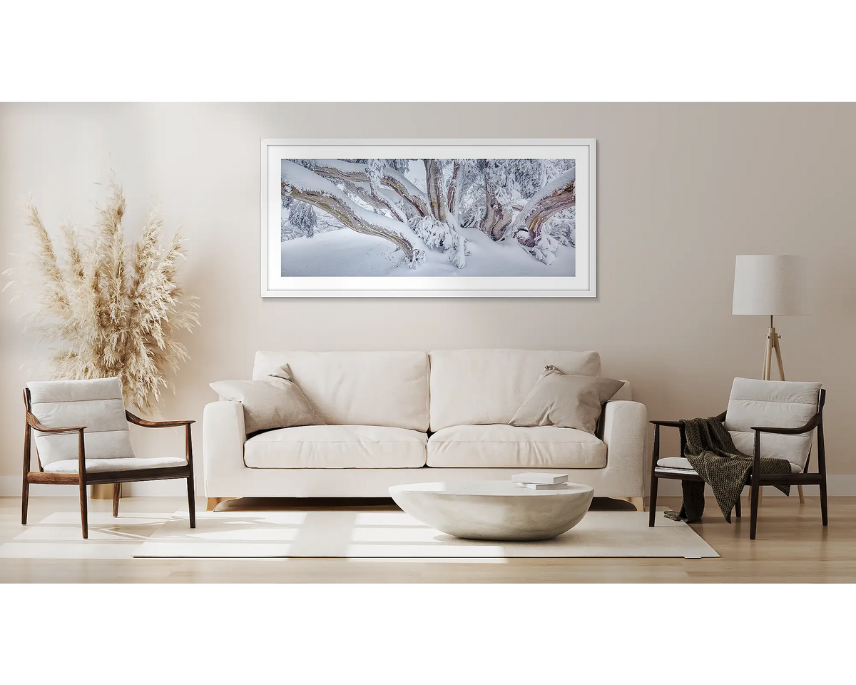 So Fresh. Snow gum covered in snow, wall art framed in a white frame, hung above a couch.