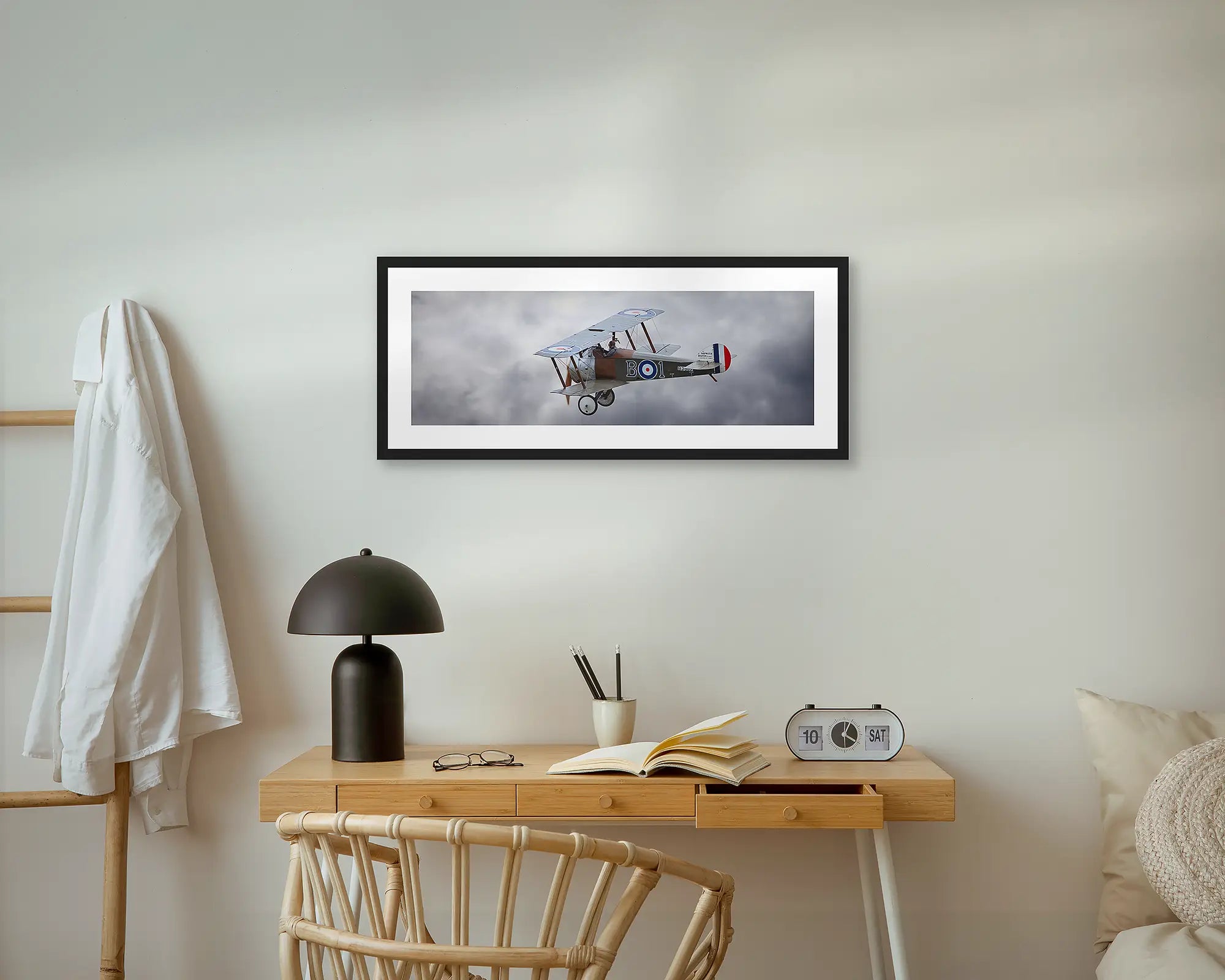 Sopwith Camel flying against backdrop of clouds.