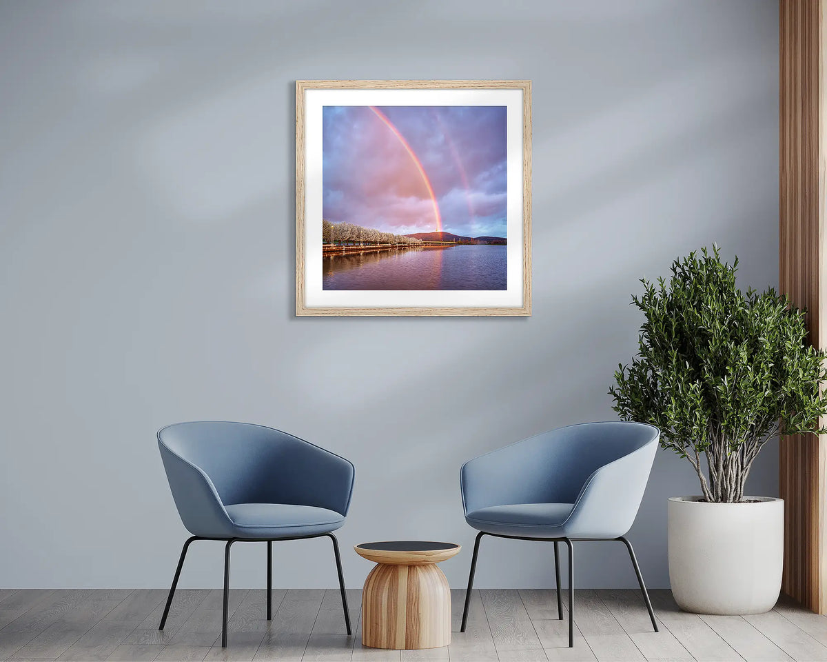 Spring Delight. Canberra rainbow wall art print, framed with a timber frame and hung above two chairs. 