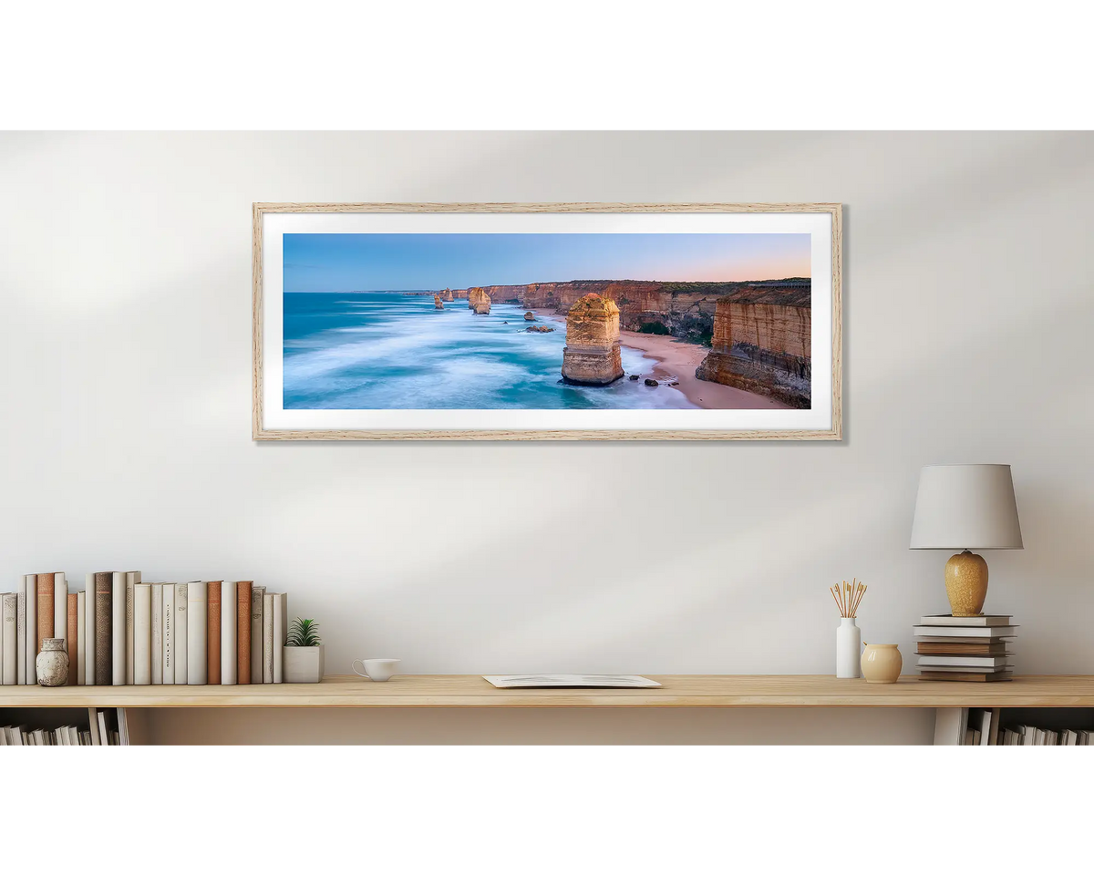 Standing Strong. Twelve Apostles panoramic wall art print, with a Tassie oak frame, in a home office. 