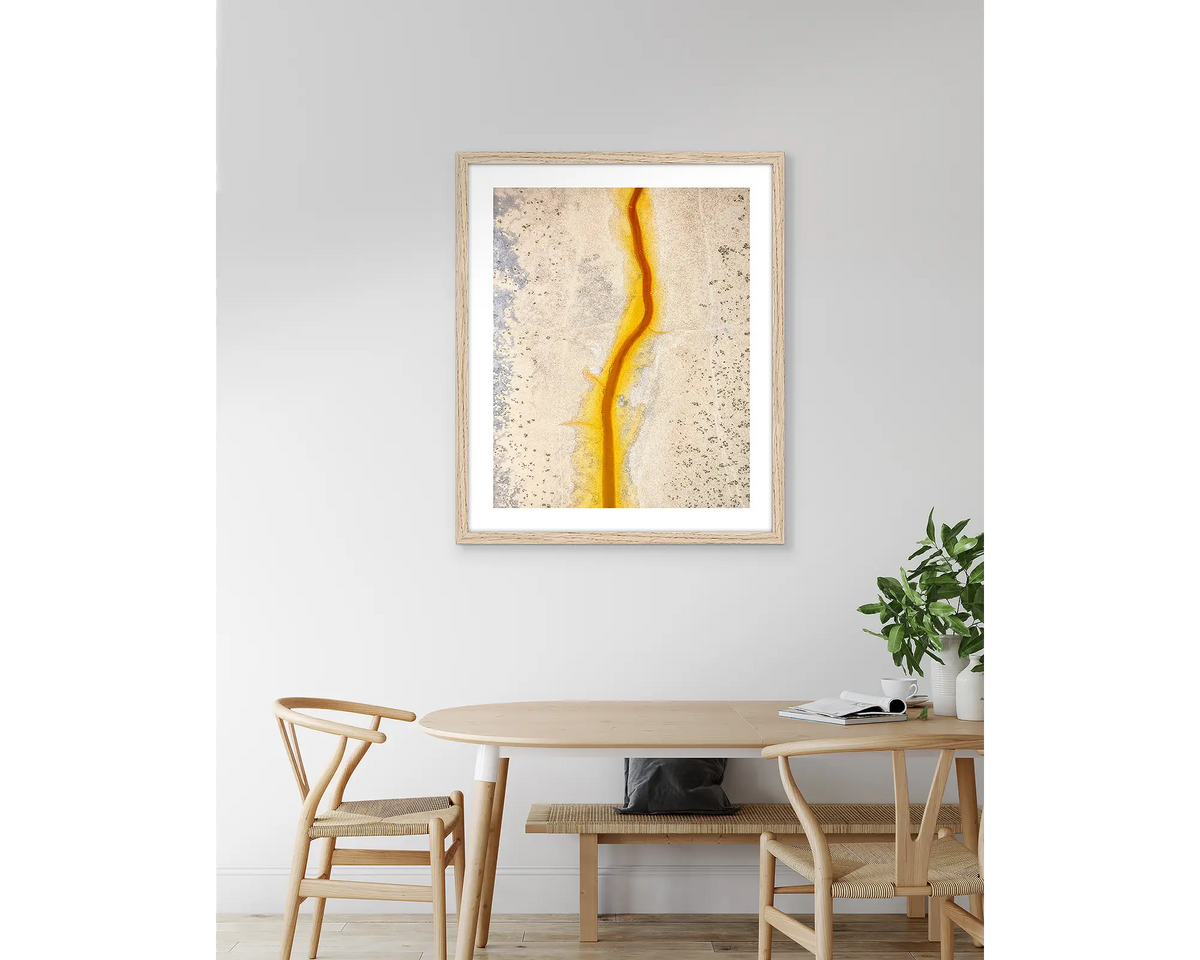 Strike. Abstract Kimberley artwork, with a timber frame, hung above a kitchen table.