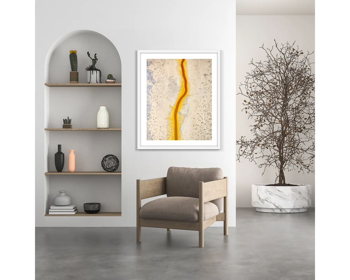 Strike. Kimberley wall art print, with a white frame, hung above a chair.