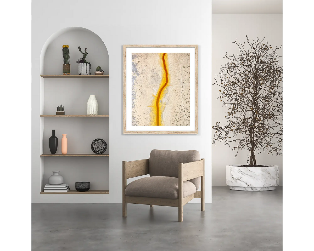 Strike. Kimberley wall art print, with a wood frame, hung above a chair.