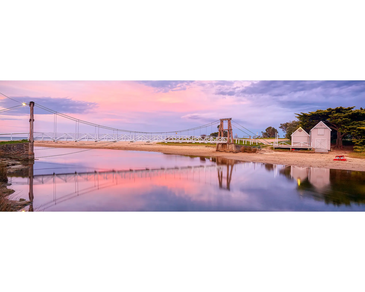 Sunset over Lorne swing bridge with reflections in the water below, Lorne, Victoria.