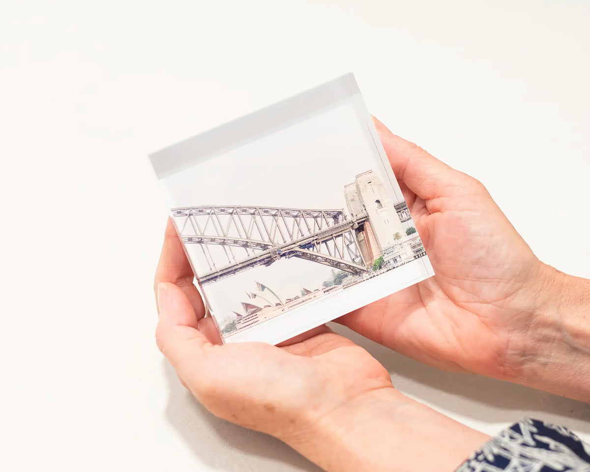 Sydney Icons. Acrylic block of Opera House and Harbor Bridge, Sydney artwork being held.