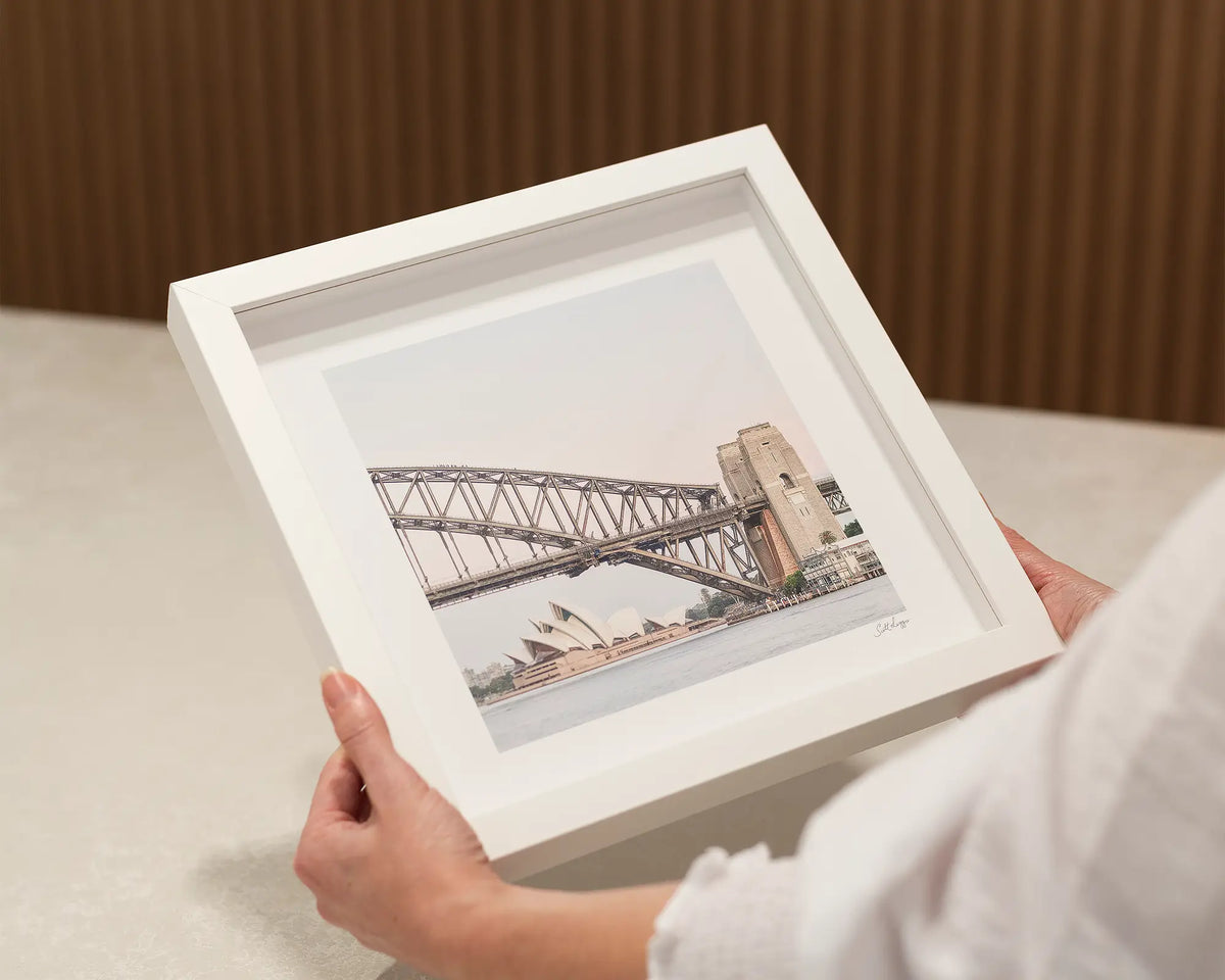 Sydney Icons. Harbor Bridge and Opera house small square framed print in a white frame.