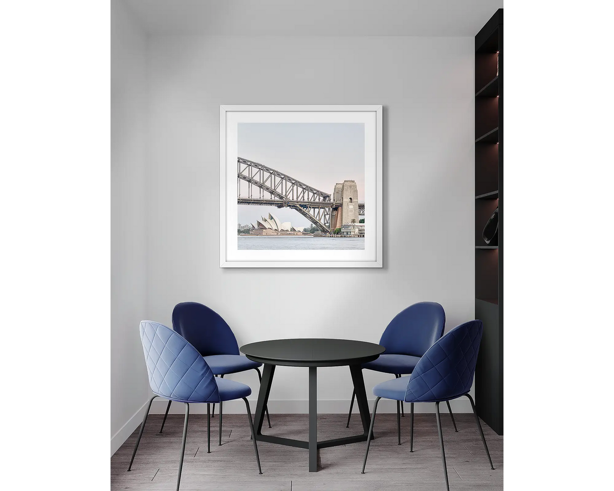 Sydney Icons. Harbour Bridge wall art print, with a white frame, in an office meeting room. 