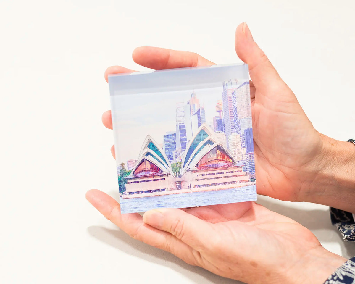 Sydney Views. Acrylic block of Opera House, Sydney artwork being held.