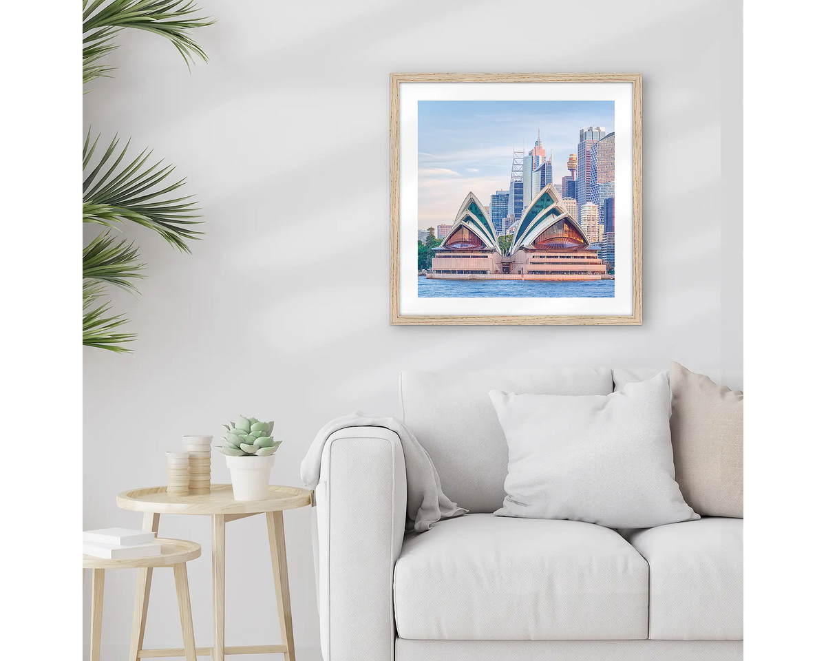 Sydney Views. Framed Opera House art work, with a Tasmanian Oak frame, hung above a couch.