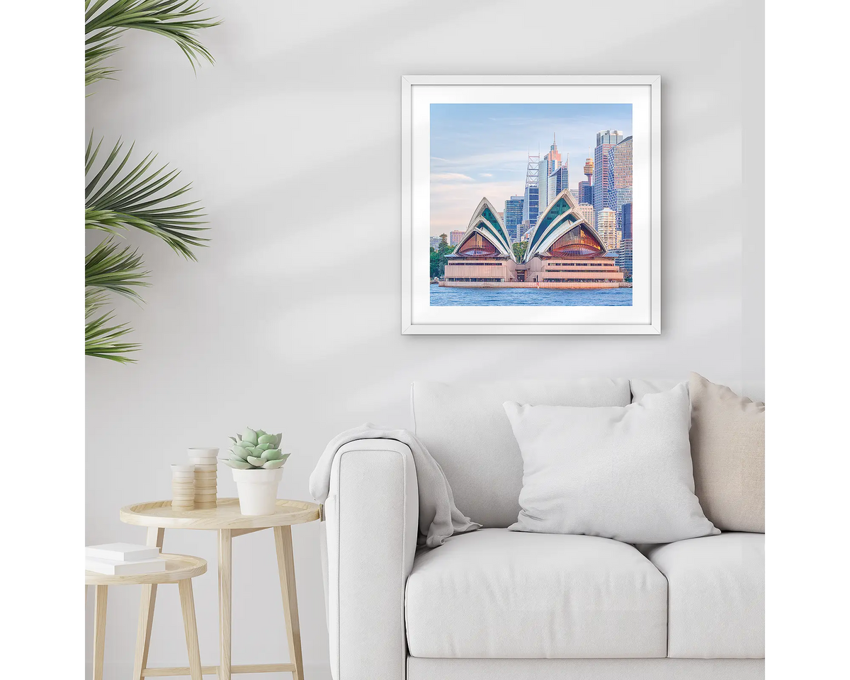 Sydney Views. Framed Opera House artwork, with a white frame, hung above a couch.