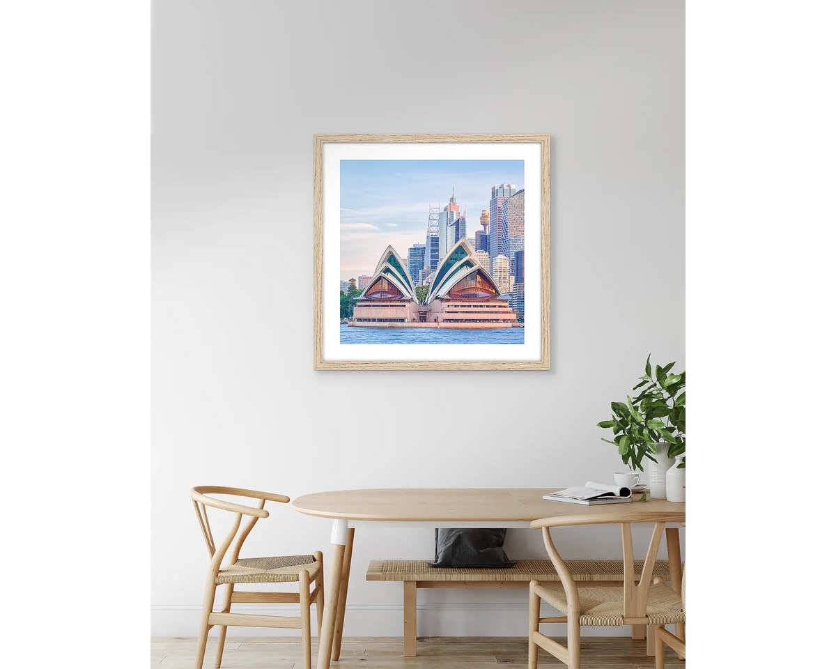 Sydney Views. Opera House artwork, with a timber frame, hung above a kitchen table.