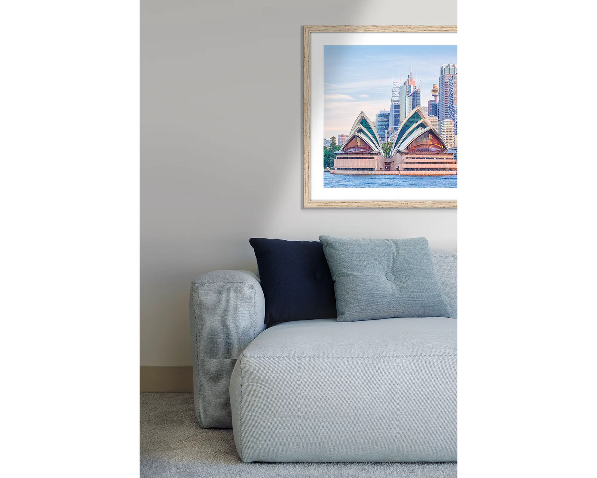 Sydney Views. Opera House, framed wall art print, with a Tasmanian Oak frame, hung above a couch.