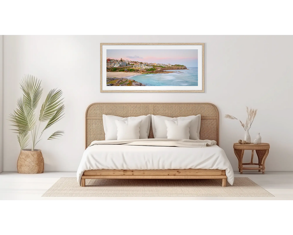 Tama Sundown. Tamarama beach sunset artwork, in a timber frame, above a bed. 