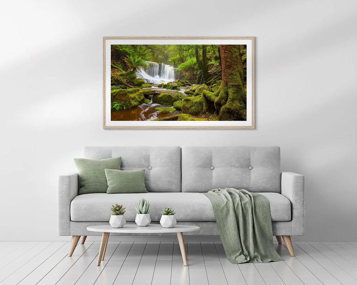 Tasmanian Escape. Horseshoe Falls, Tasmania wall art print, with a timber frame, above a couch. 