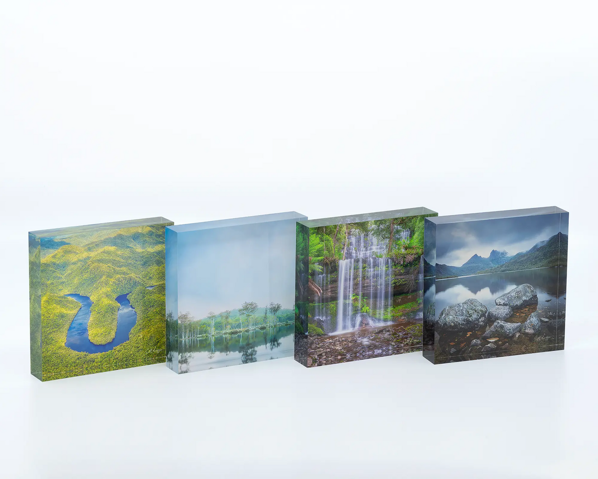 The Bend acrylic blocks displayed next to other acrylic blocks featuring photographs of Tasmanian landscapes. 