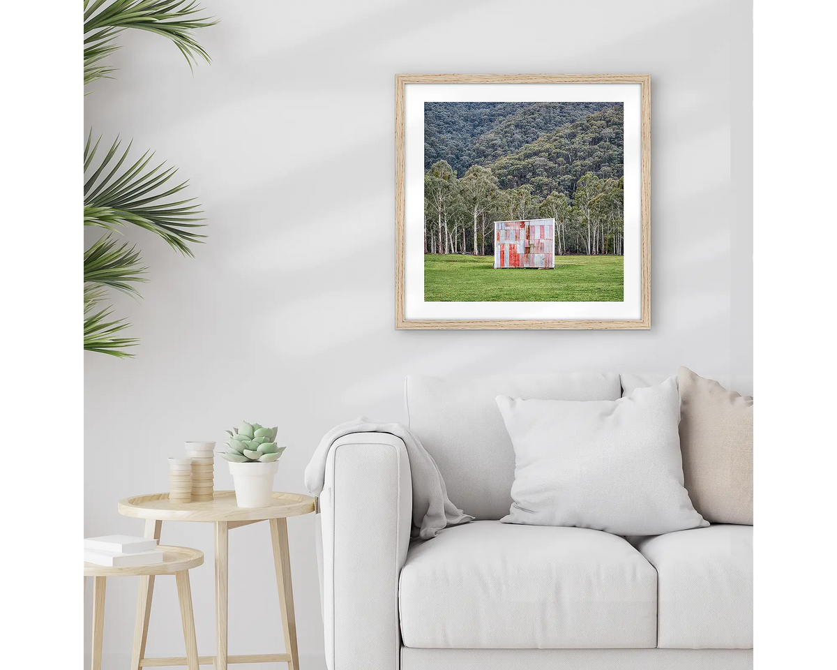 The Box. Framed farm shed wall art print, with a timber frame, hung above a couch.