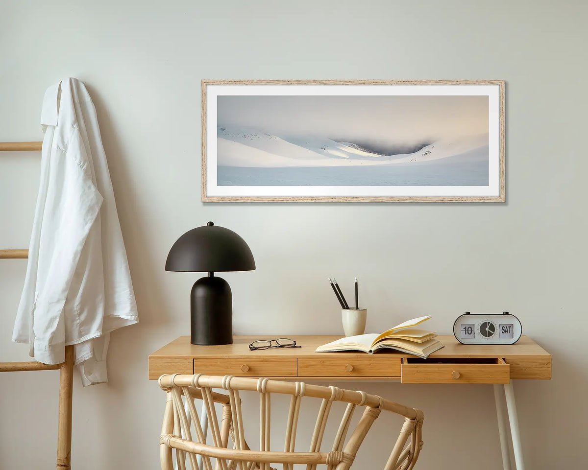 The Chute. Winter snow wall art print with timber frame hung above small desk.