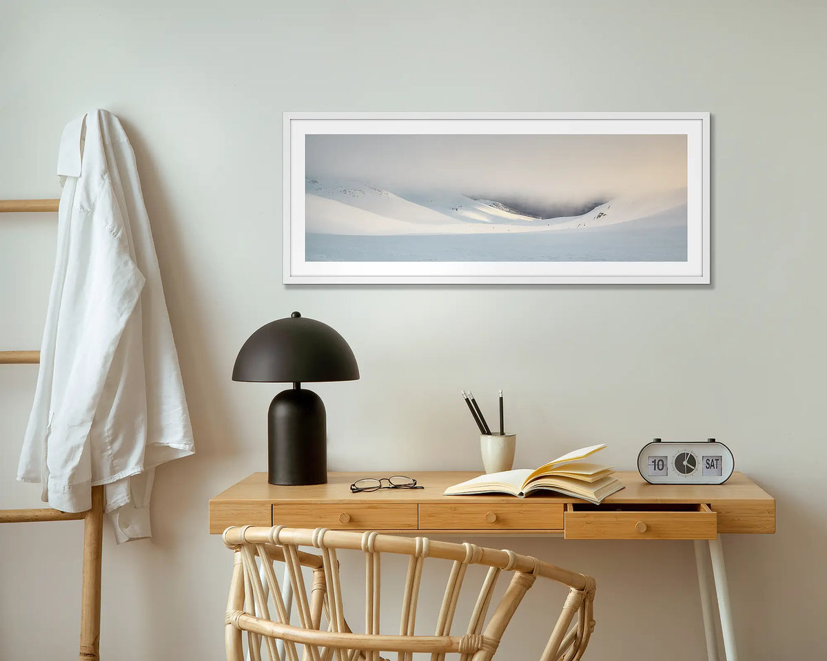 The Chute. Winter snow wall art print with white frame hung above small desk.