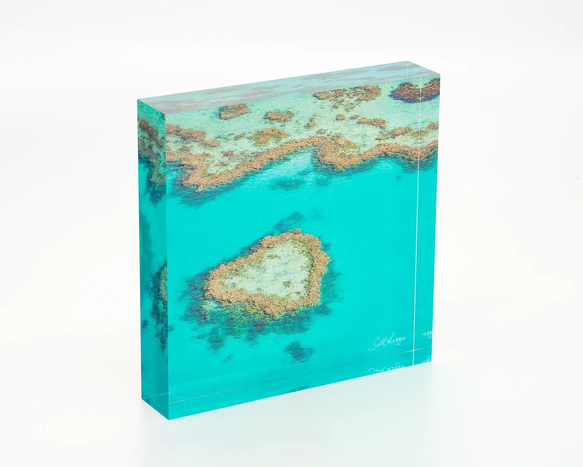 The Heart acrylic desk block displayed on a desk - photograph of a heart shaped reef in the Great Barrier Reef, Queensland. 