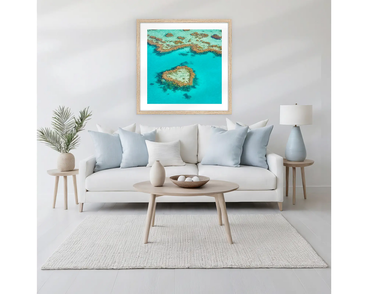 The Heart. Great Barrier Reef wall art in  a Tasmanian Oak frame, hanging above  a couch.