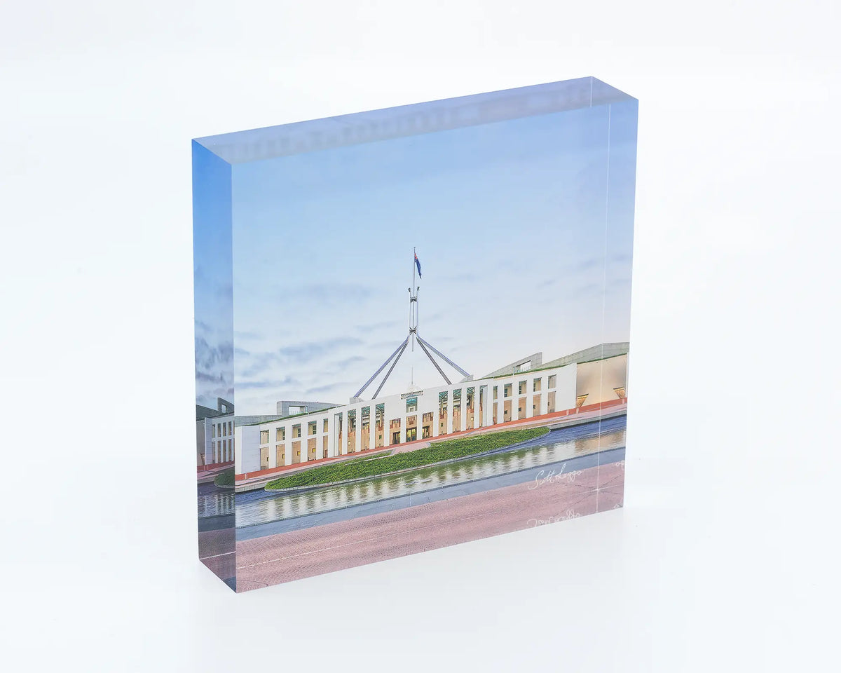 The Hill acrylic block displayed on a desk. Photograph of Australian Parliament House, Canberra, ACT. 