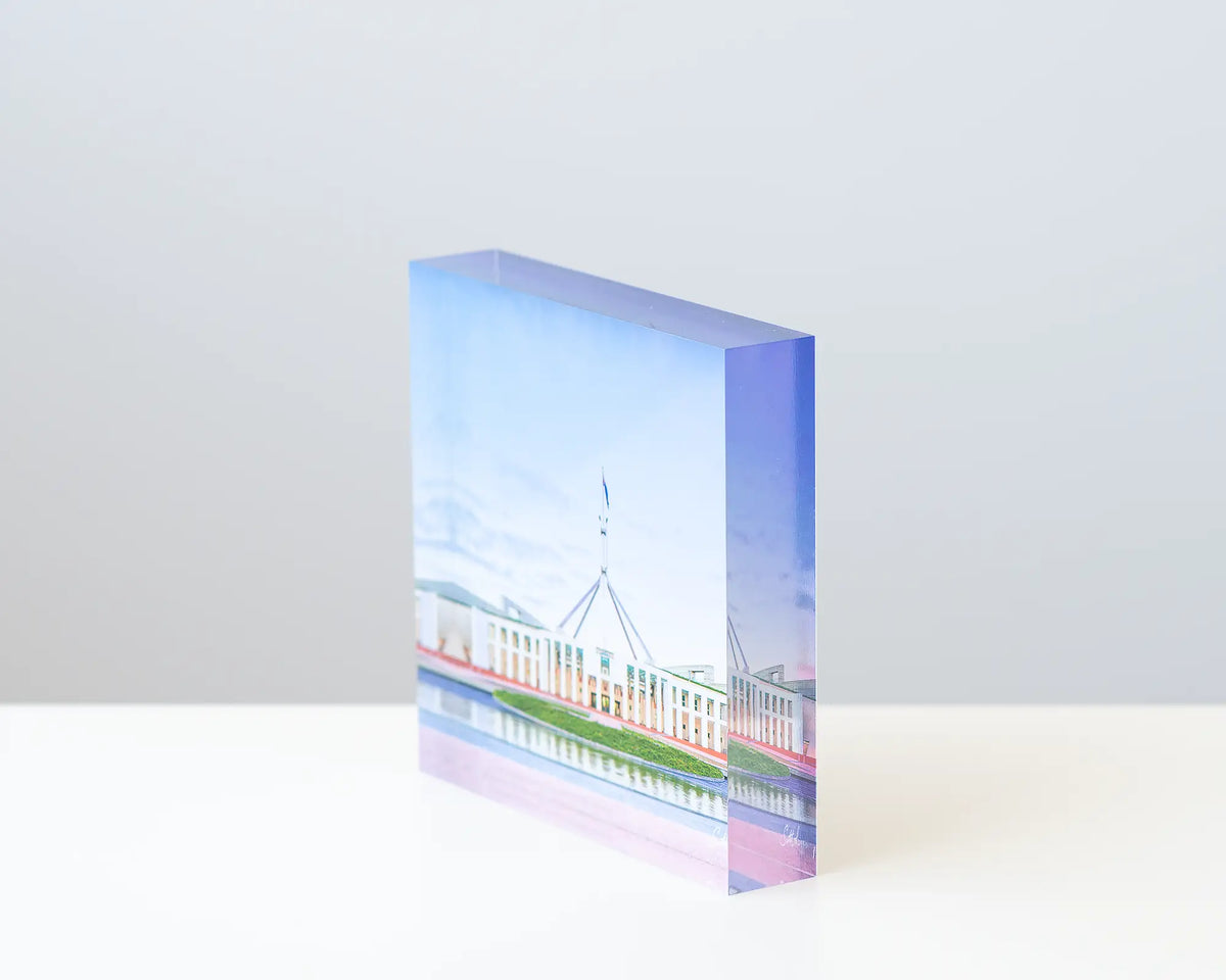 The Hill acrylic block displayed on a desk. 