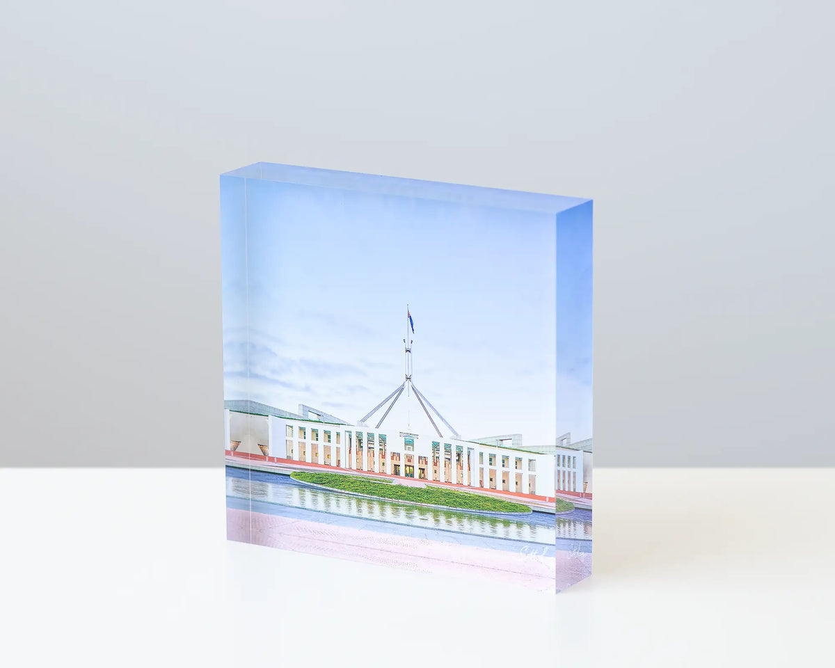 The Hill 10cm acrylic block displayed on a desk. 