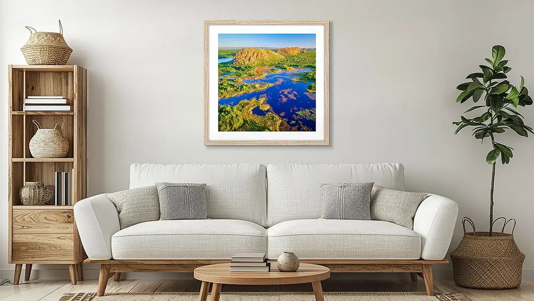 The Kimberley wall art print with timber frame above couch.