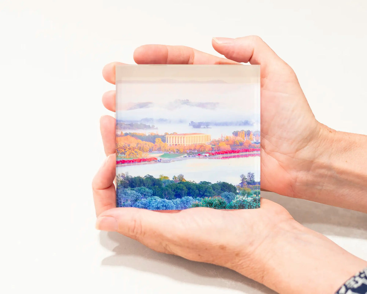 The Library. Acrylic block of the National Library of Australia, Canberra artwork being held.