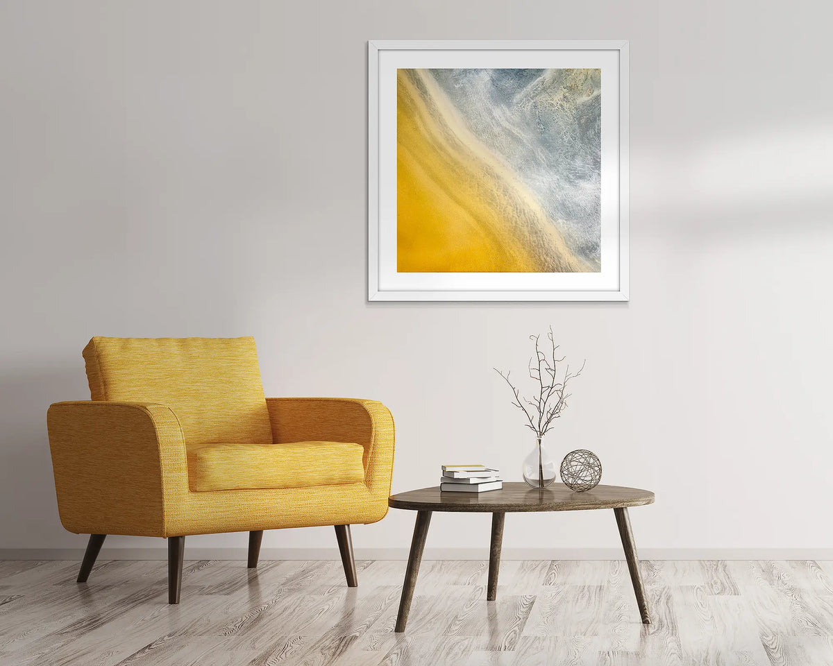 The Line. Aerial abstract artwork with white frame hung above lounge chair.