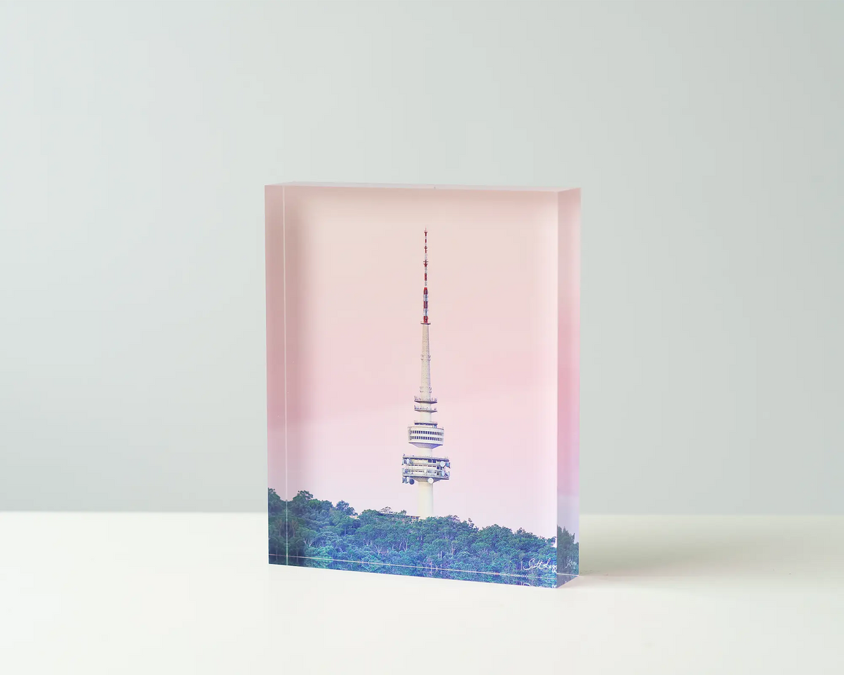 The Needle. Acrylic block of Telstra tower and Black mountain tower with a pink sunset. Canberra artwork on table.