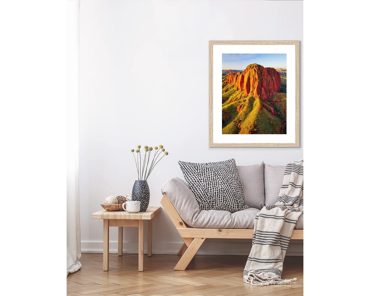 The Rock. Kimberley wall art print, in a Tasmanian Oak frame, hanging above a couch.