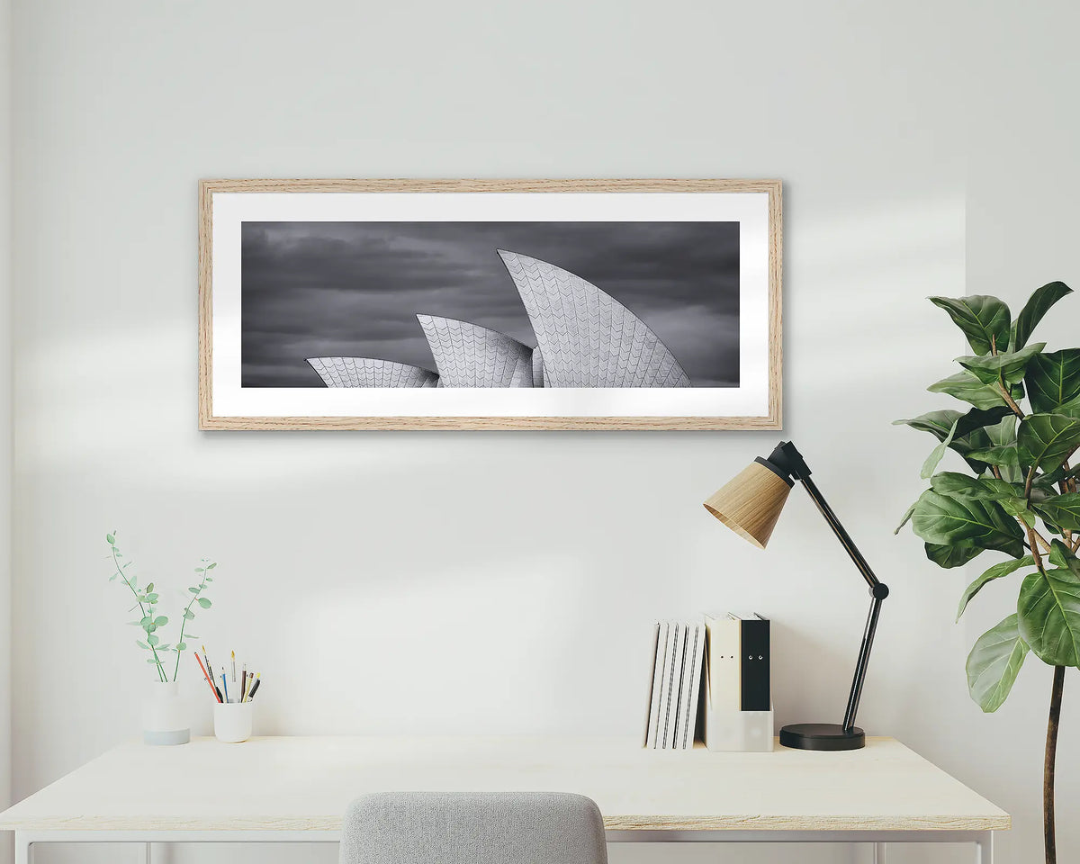 Three Sails. Sydney Opera House wall art print, with a timber frame, hung above a home office desk. 