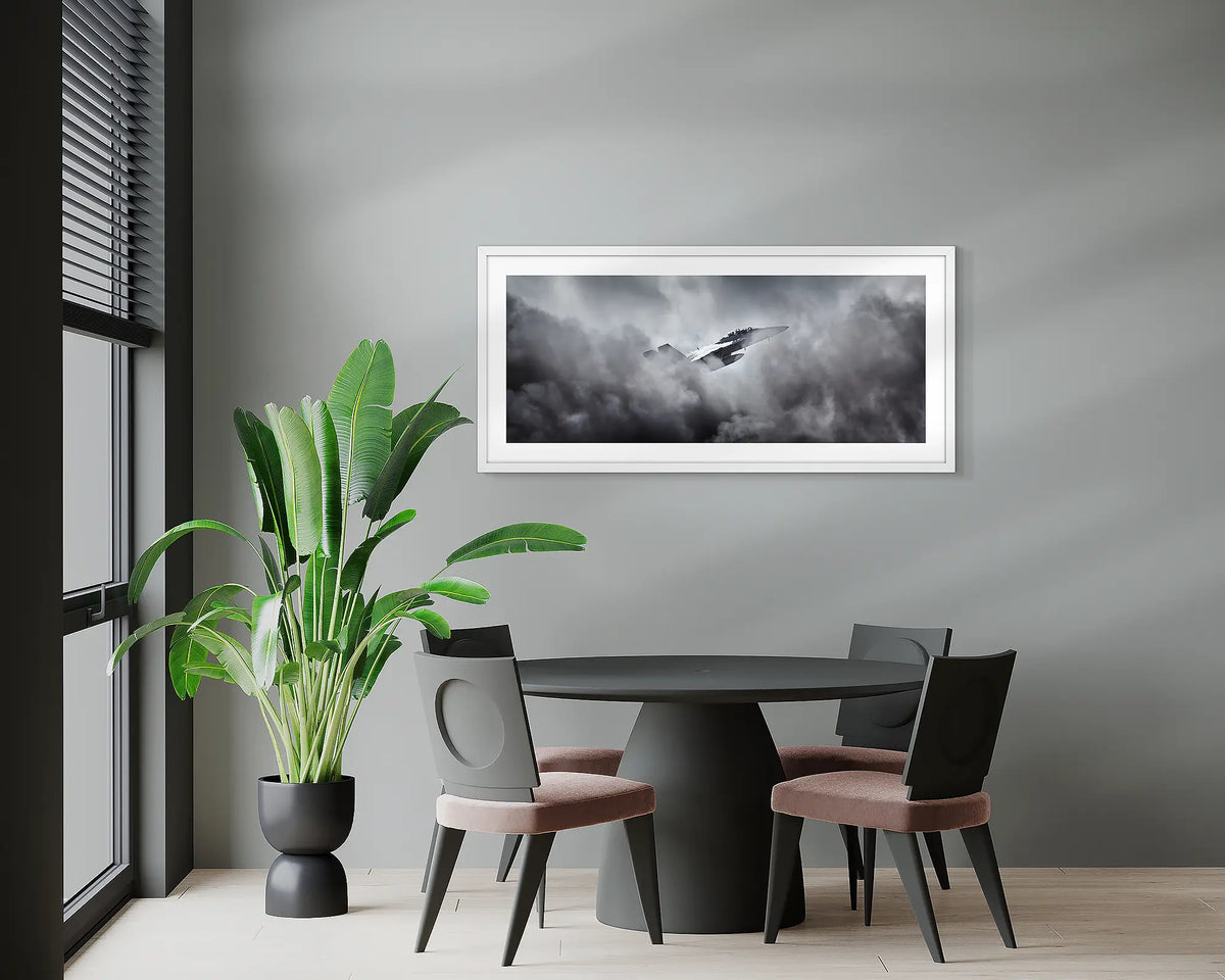 Through the Fire. F-18 Hornet, wall art print, with a white frame, hung above a meeting room table.