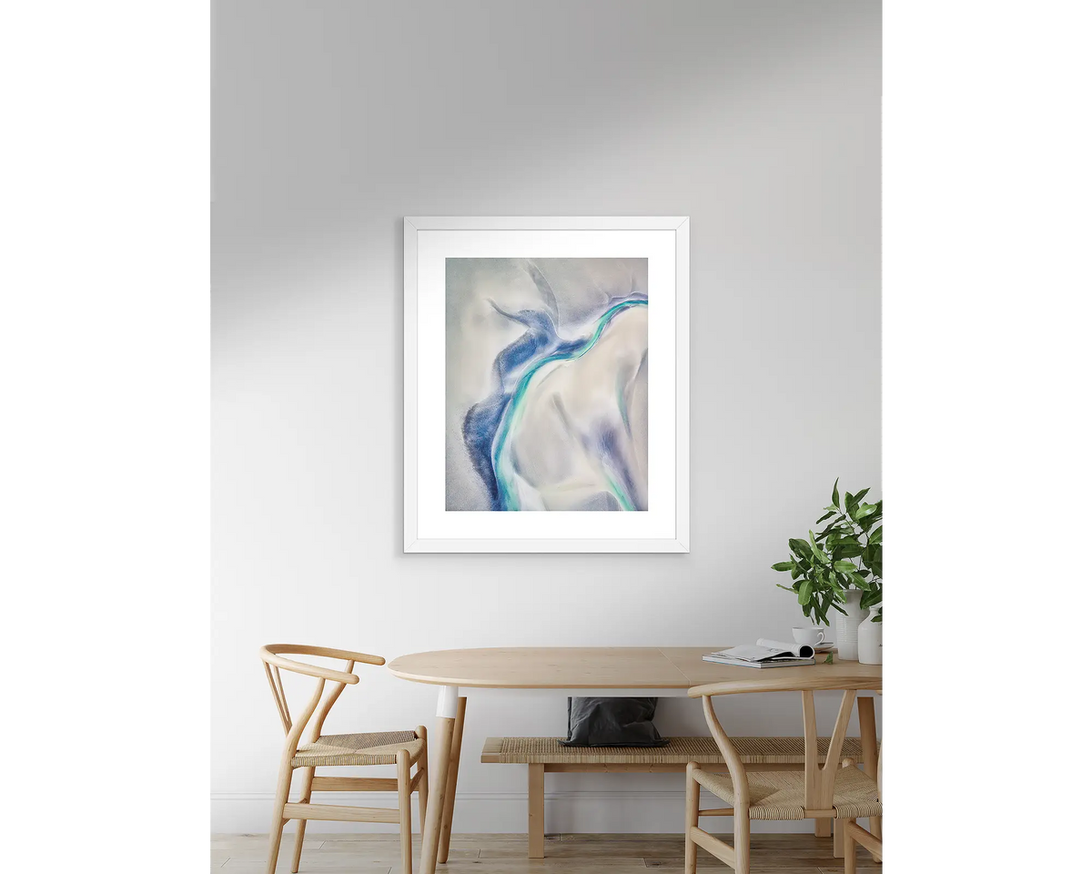Tidal Orchid abstract artwork with white frame hanging above table.