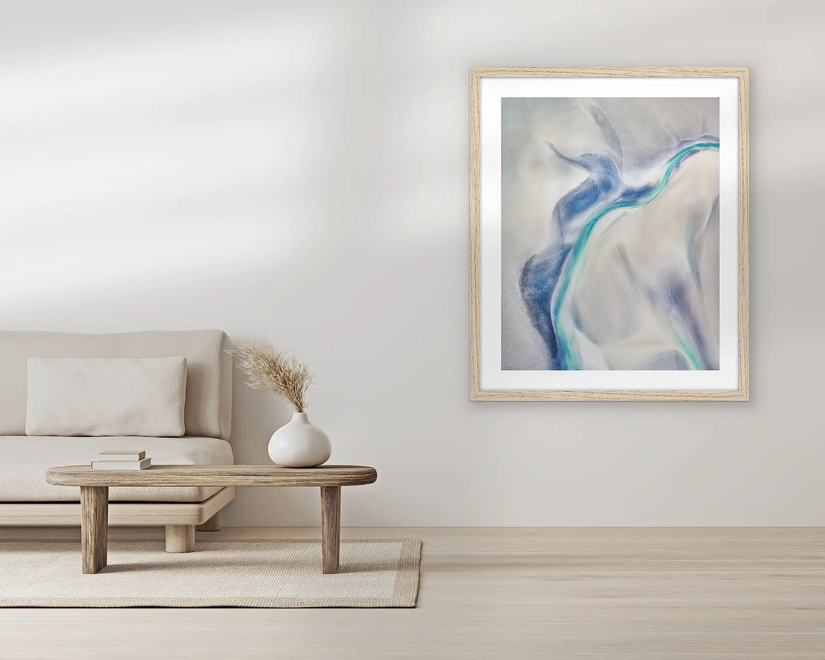 Tidal Orchid. Aerial wall art print, with a Tassie oak frame, in a living room.