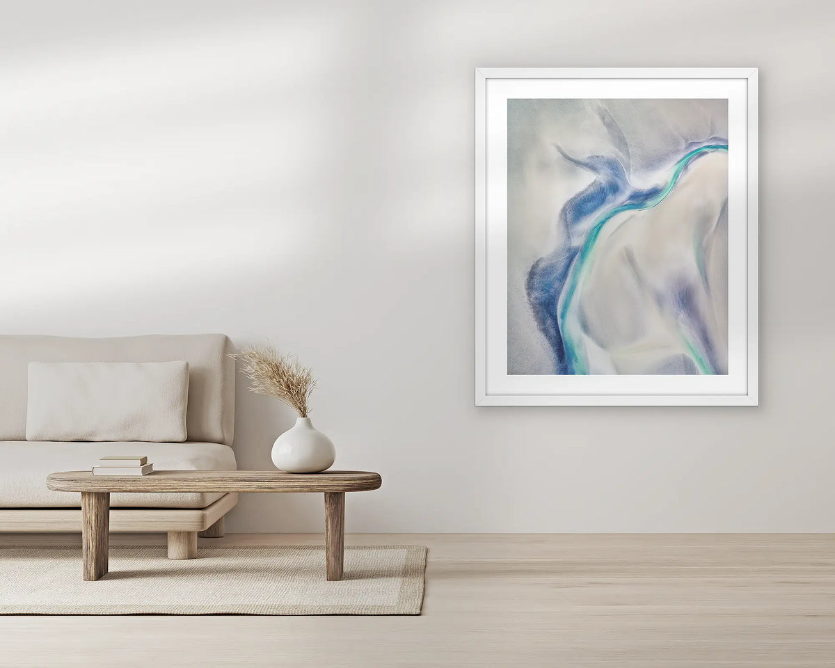 Tidal Orchid. Aerial wall art print, with a white frame, in a living room.