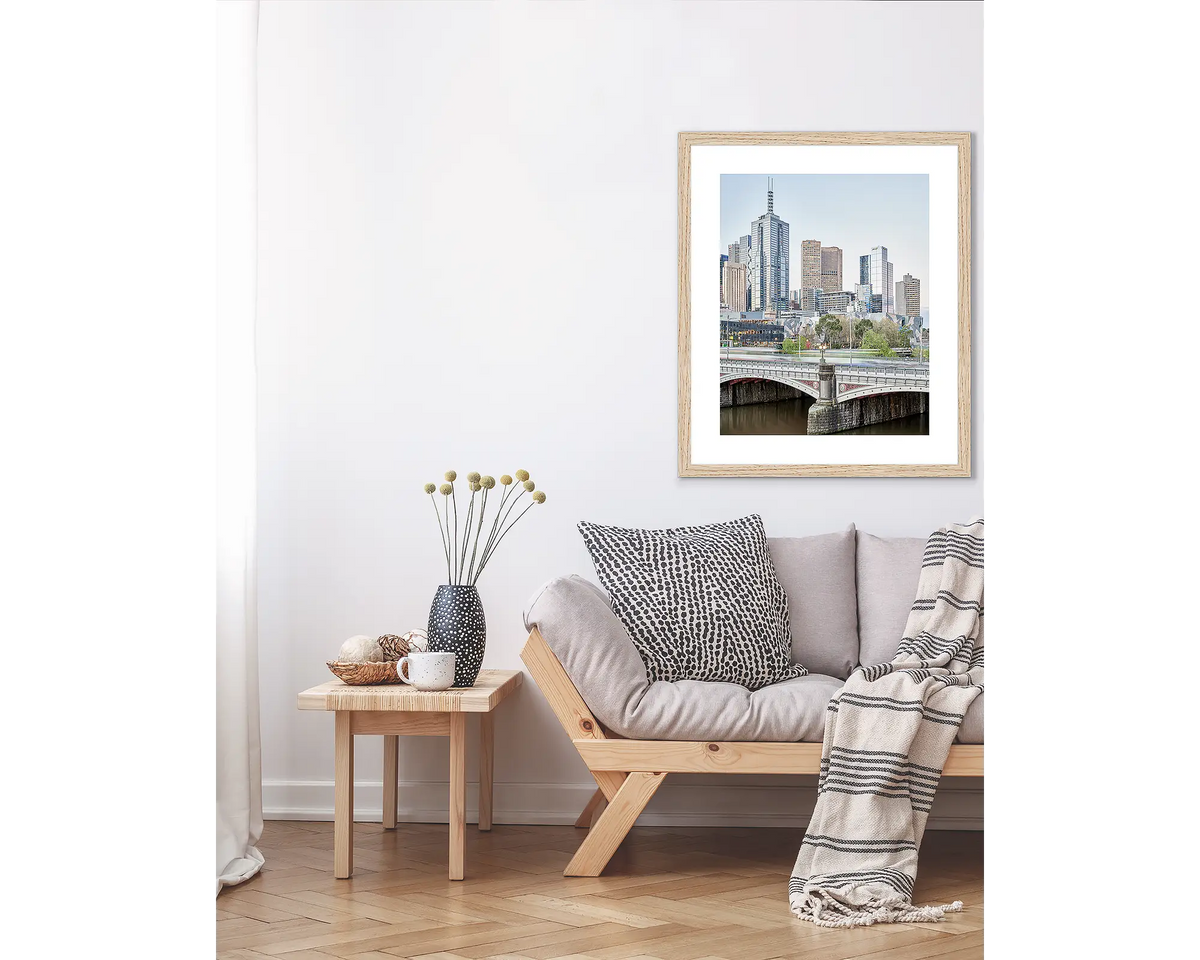 Top End. Melbourne wall art print, in a Tasmanian Oak frame, hanging above a couch.