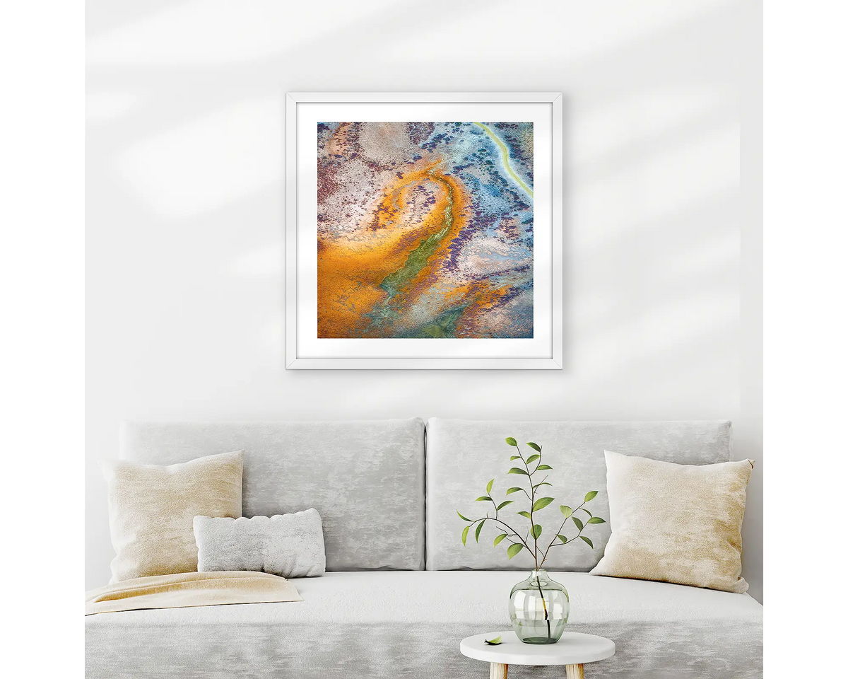 Trails. Abstract Kimberley wall art print with white frame hung above couch.