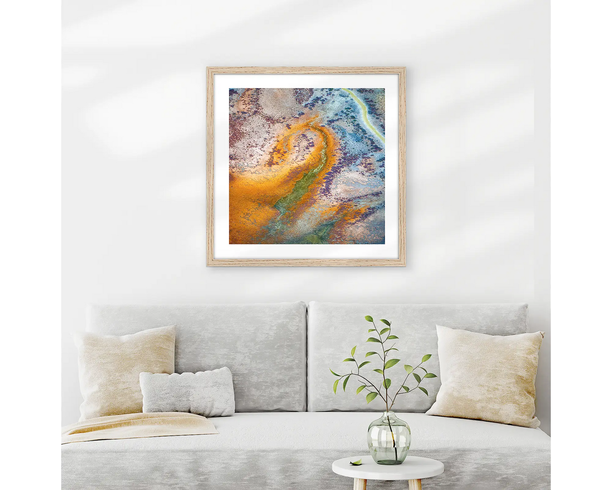 Trails. Abstract Kimberley wall art print with wood frame hung above couch.