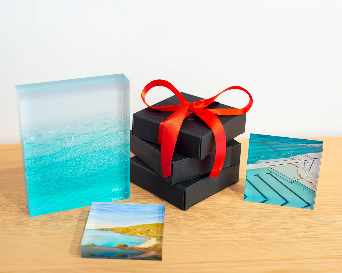 Tranquility acrylic block displayed with other coastal blocks and gift boxes.