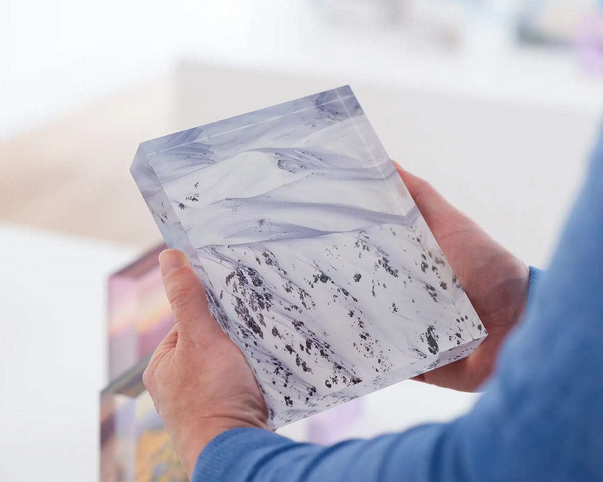 Unveiled. Acrylic block of main range in Kosciuszko National Park in New South Wales. Australian artwork being held.