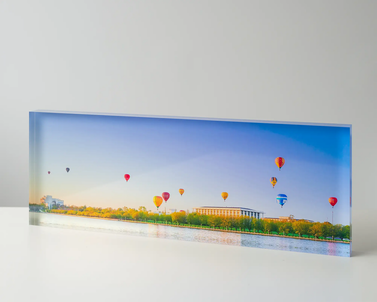 Upwards. Acrylic block of the balloon spectacular in Canberra. Australian artwork on table.